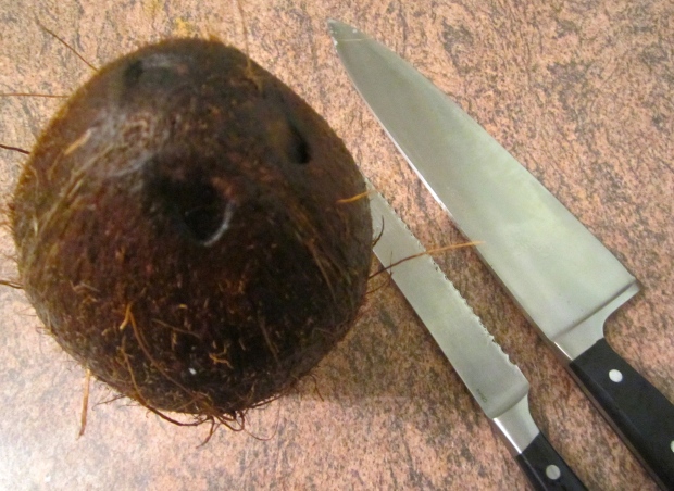 to split the coconut, saw a small inision around the outside of the coco, then crack it with the back of a large chefsknife or machete (I live in Florida where it is normal to have a machete in the house) :-)
