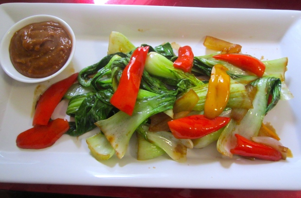 plate bok choy and a small side dish with peanut sauce for dipping